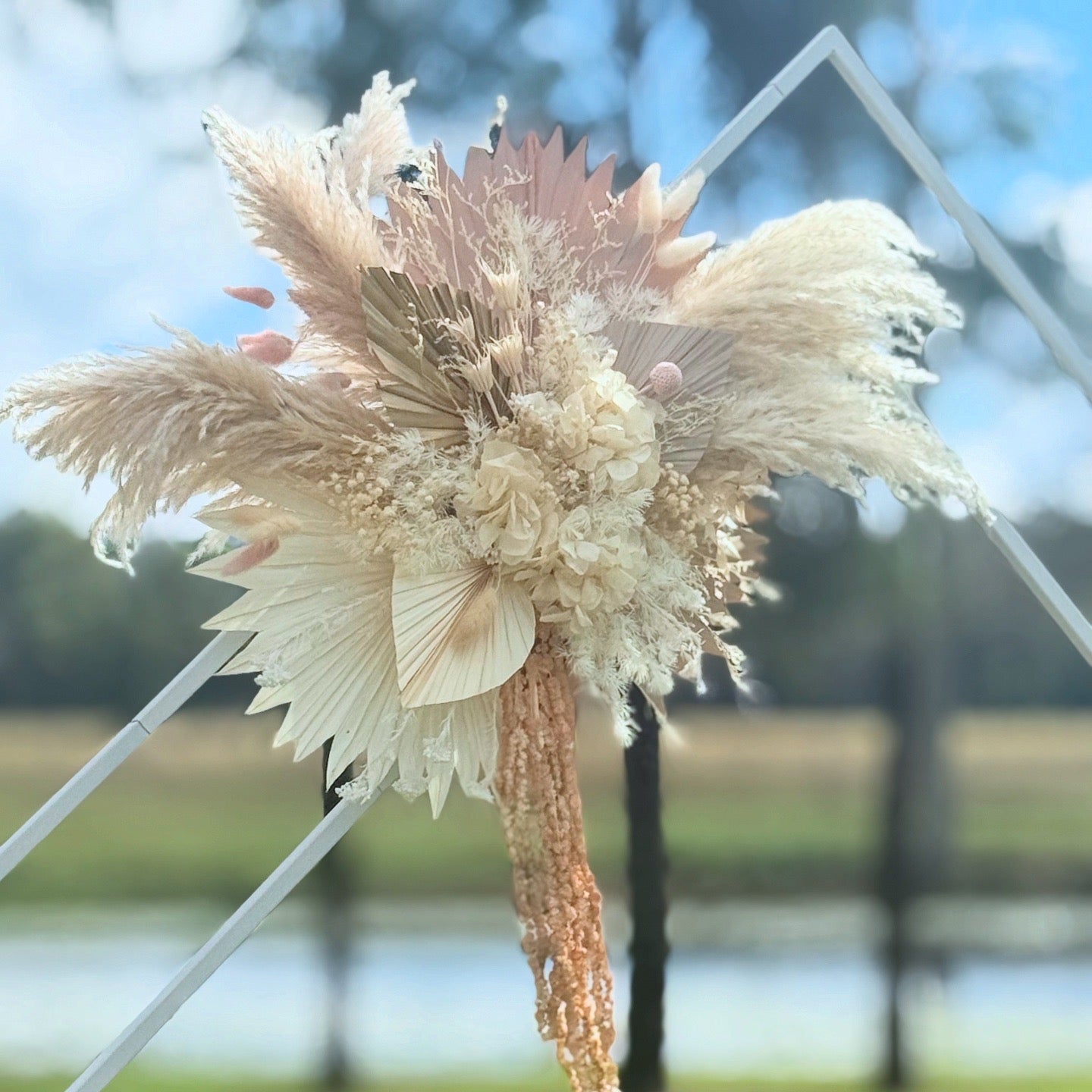 Decorative dried flower arrangement with a blurred natural background