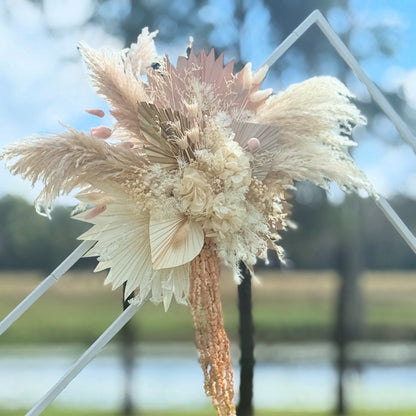Decorative dried flower arrangement with a blurred natural background