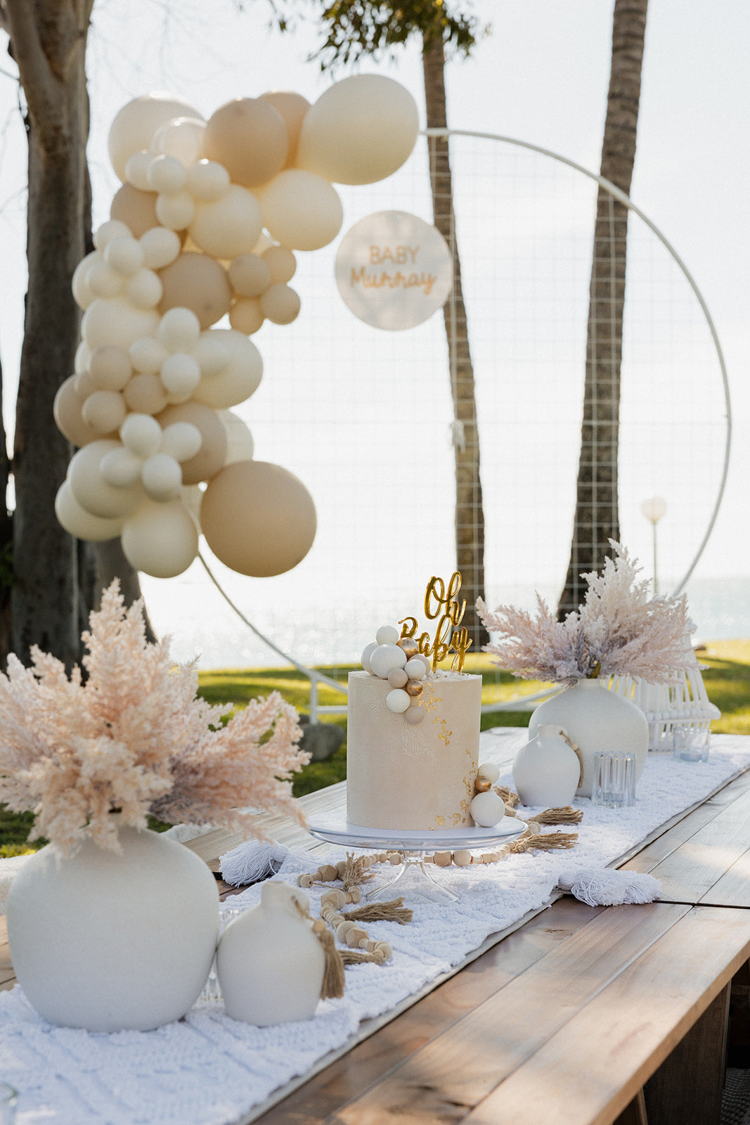Balloon arch and neutral table styling for baby shower