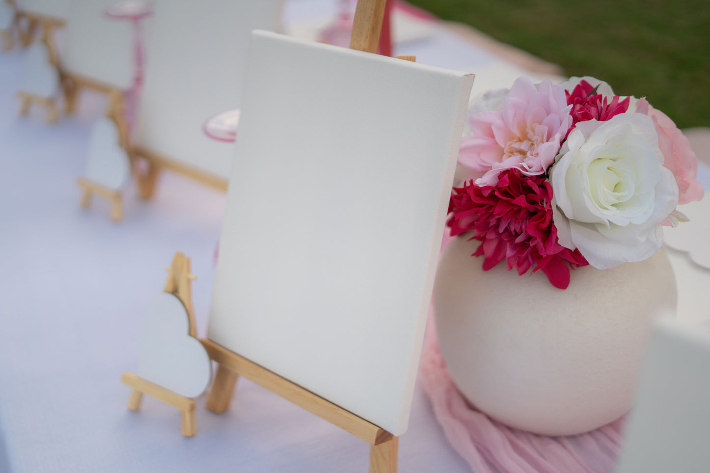Decorative setup with pink and white flowers on a white surface