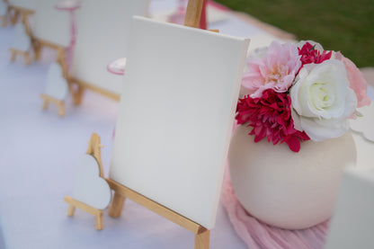 Decorative setup with pink and white flowers on a white surface