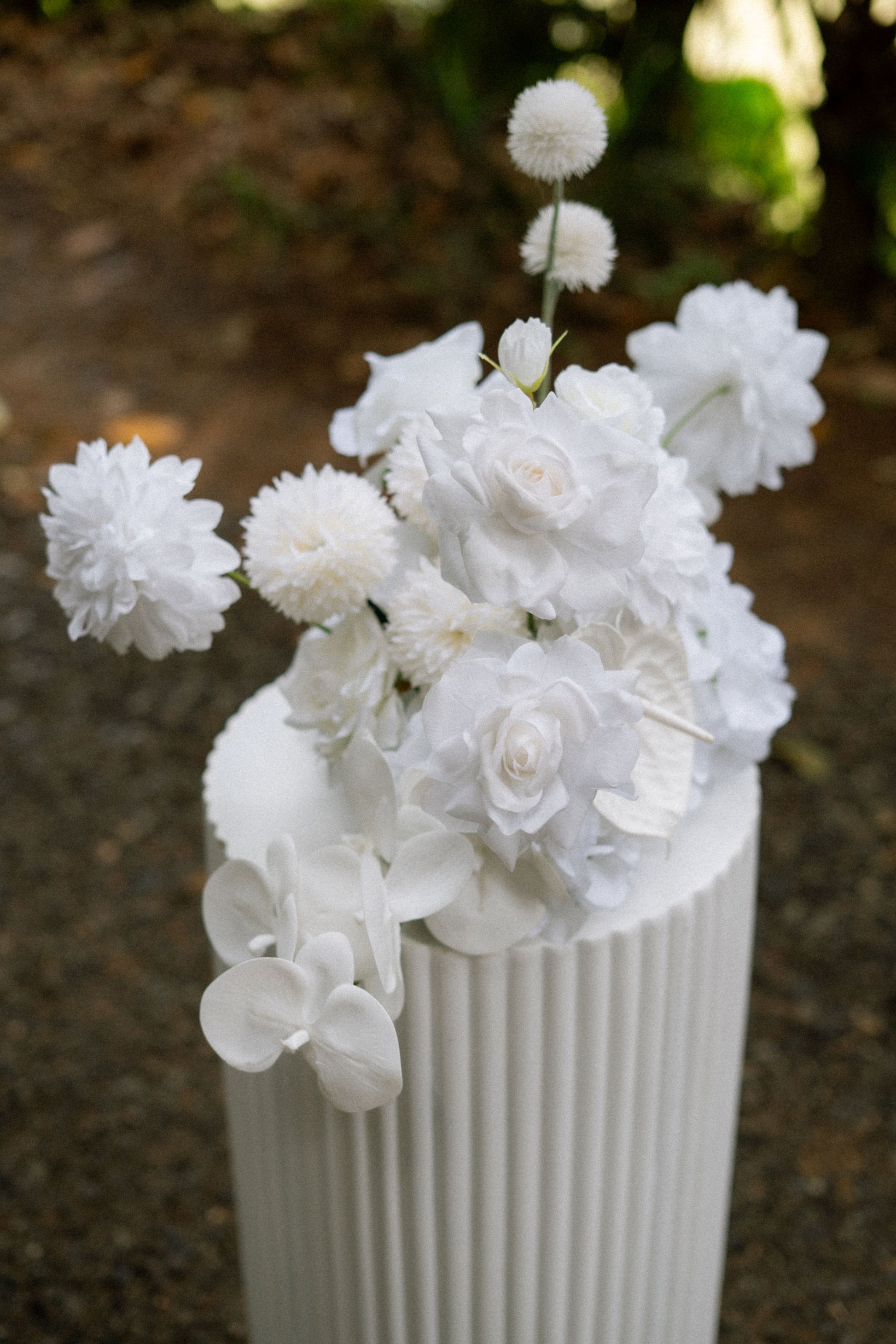 elopement package set up white plinths and faux flowers wicker and white warwick